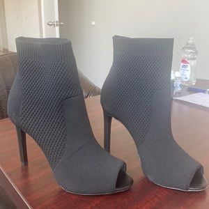 Size 8 black high heel stretchy peel toe bootie.